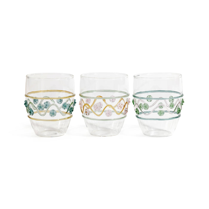Three decorative glass tumblers with floral patterns on a white background