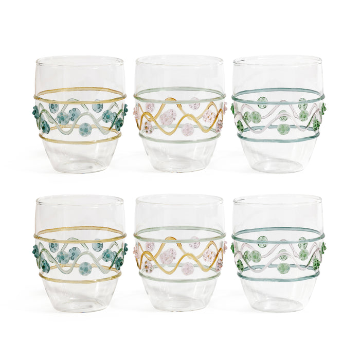 Set of six decorative glass tumblers with floral and wavy patterns on a white background