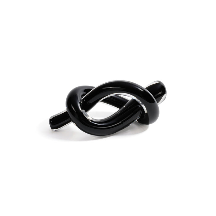 Black knot-shaped object on a white background