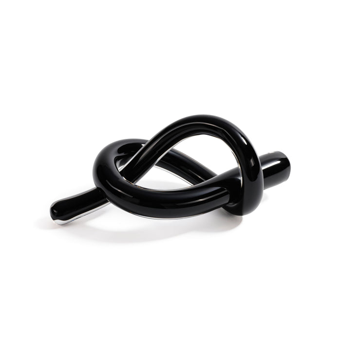 Black knot-shaped object on a white background