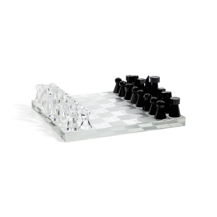 Clear acrylic chessboard with black and white chess pieces on a white background