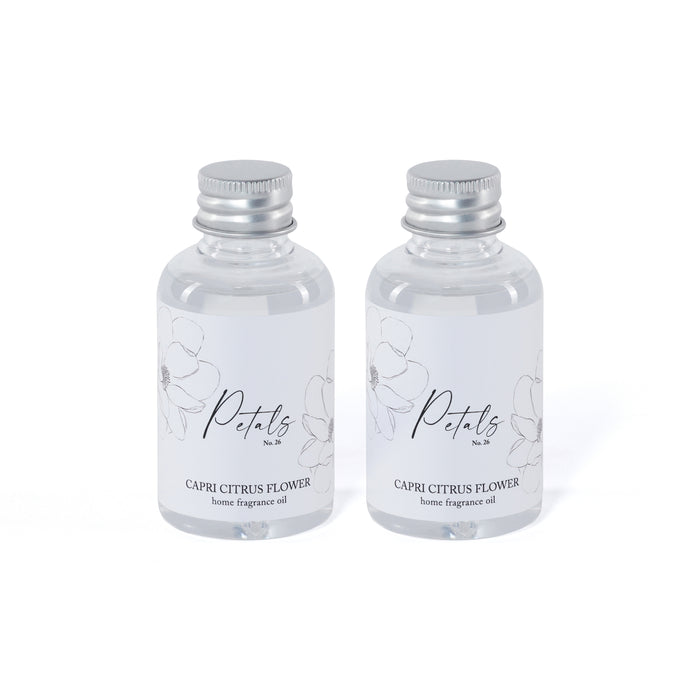 Two bottles of Petals Capri Citrus Flower home fragrance oil on a white background