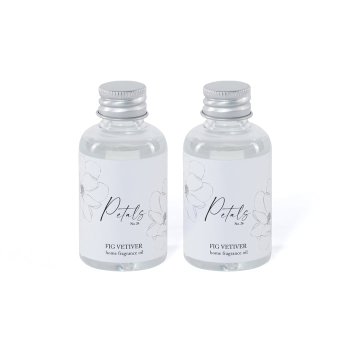 Two bottles of Petals Fig Vetiver home fragrance oil on a white background