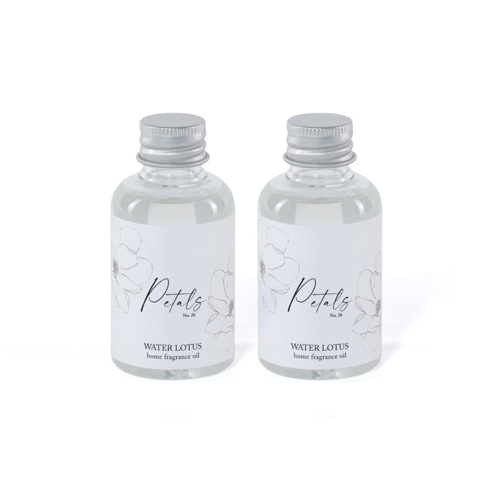 Two bottles of Petals Water Lotus home fragrance oil on a white background