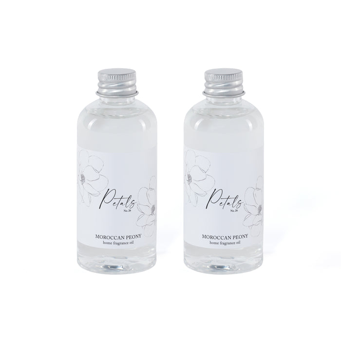 Two clear bottles of Moroccan Peony home fragrance oil with silver caps on a white background.