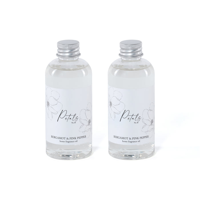 Two clear bottles of Bergamot & Pink Pepper home fragrance oil with silver caps on a white background.