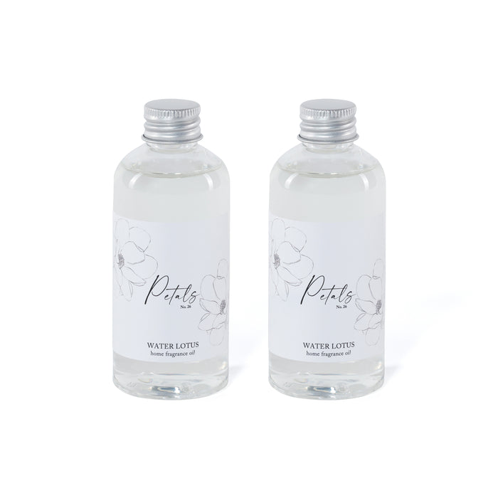 Two clear bottles of Petals Water Lotus home fragrance oil on a white background