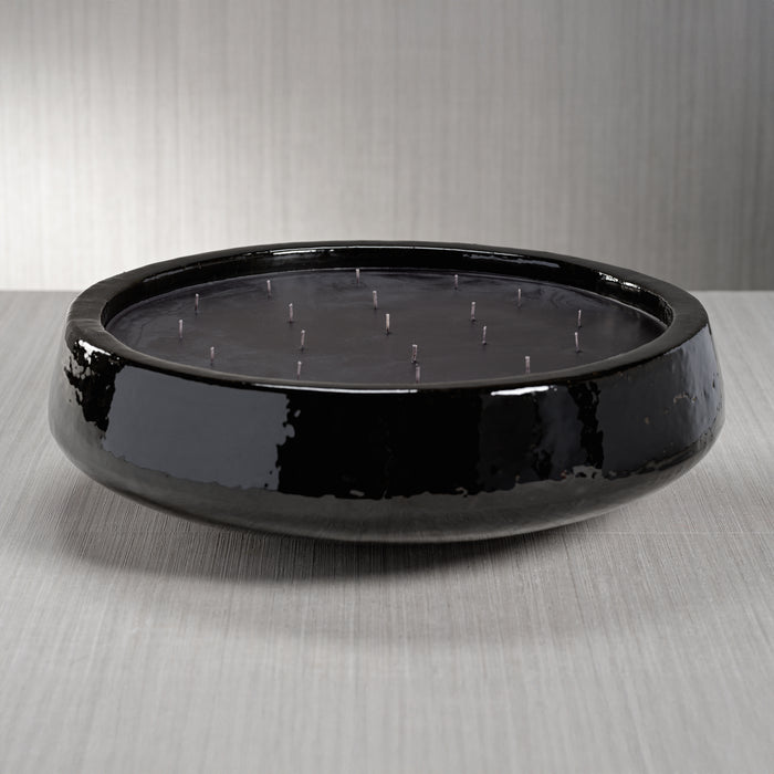 Black solar panel on a gray surface with a neutral background