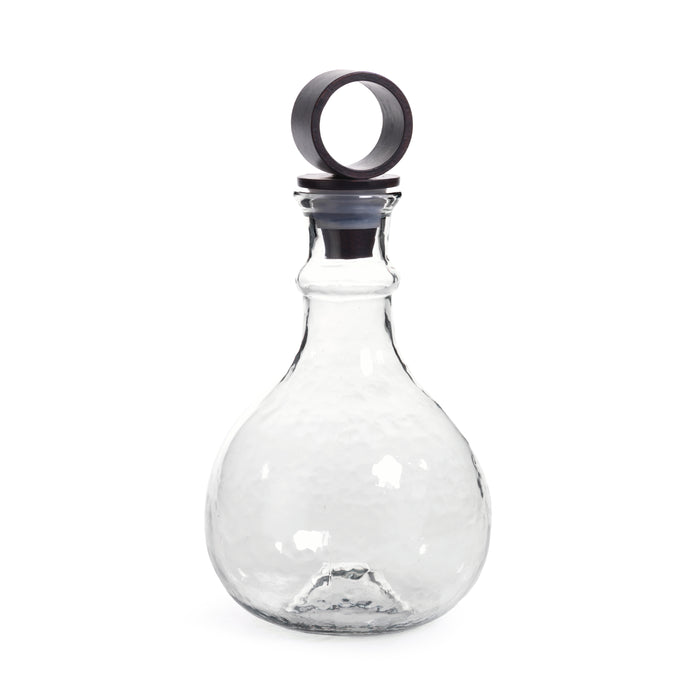 Clear glass bottle with a metallic cap on a white background
