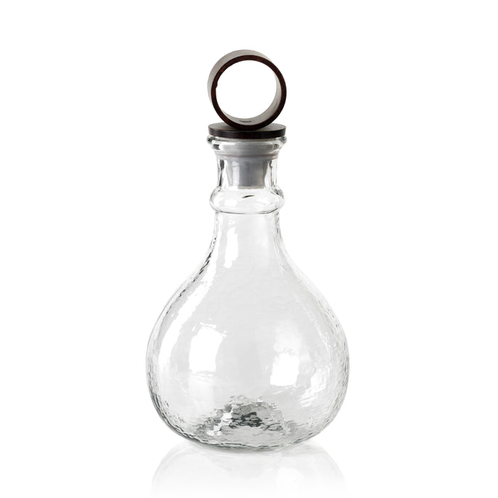 Clear glass bottle with a metal cap on a white background