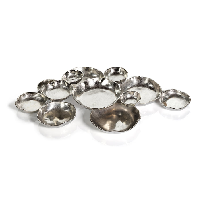 A set of twelve round silver aluminum serving bowls of varying sizes arranged in a cluster.