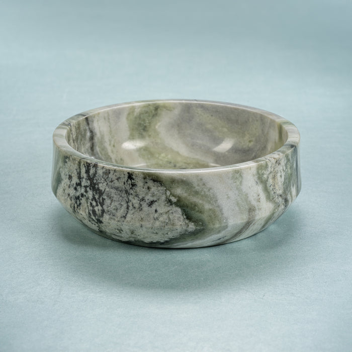 Marble-patterned stone bowl on a light blue background
