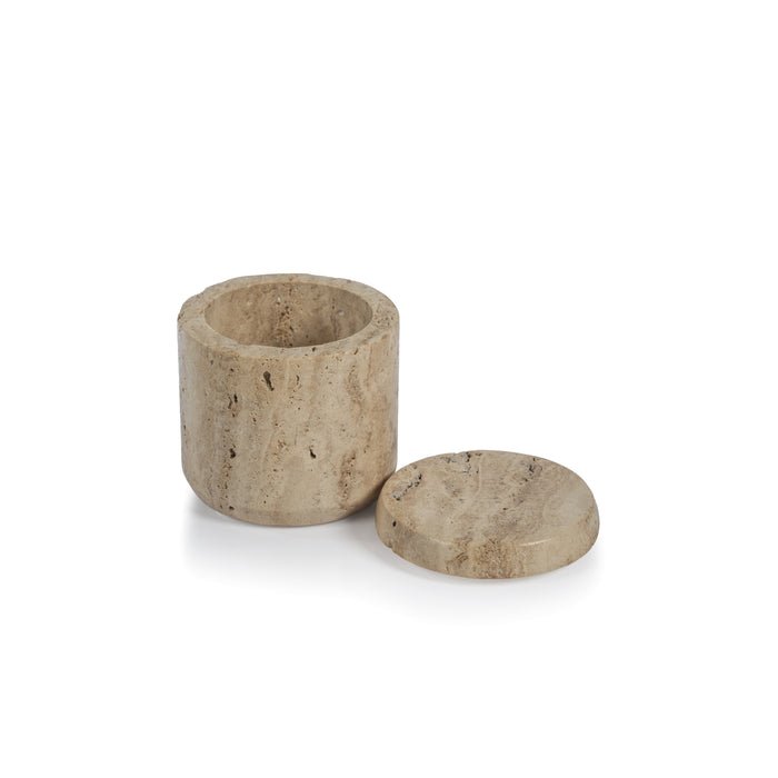 Beige travertine marble lidded canister with cylindrical body and round flat lid on white background.