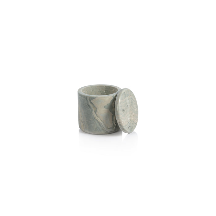 A small decorative marble jar with a lid, featuring a light blue color and detailed pattern, placed on a white surface.