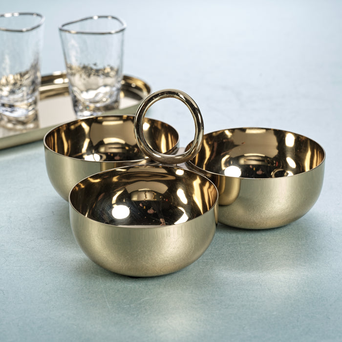 Set of gold bowls with a handle on a light blue surface