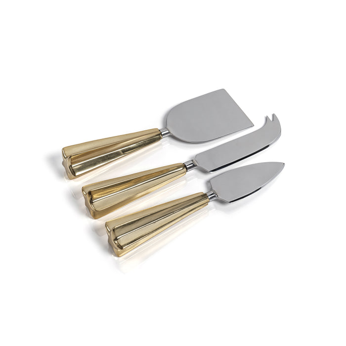 Set of four cheese knives with gold handles on a white background