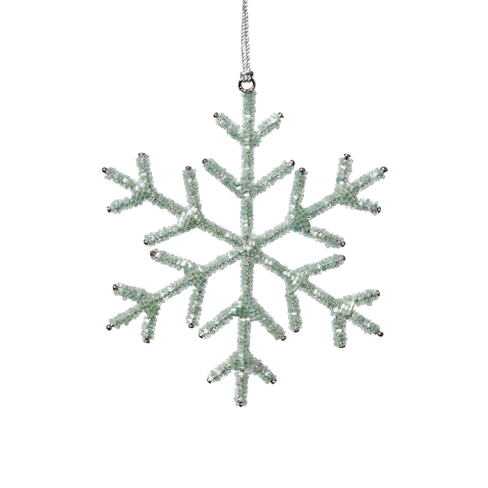 Decorative snowflake ornament with a textured surface on a white background