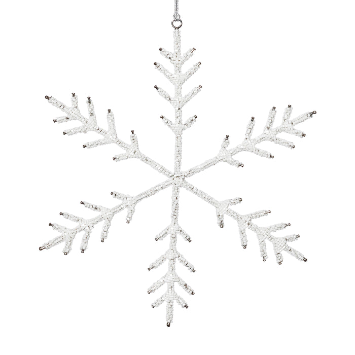 Decorative snowflake ornament with beaded details on a white background