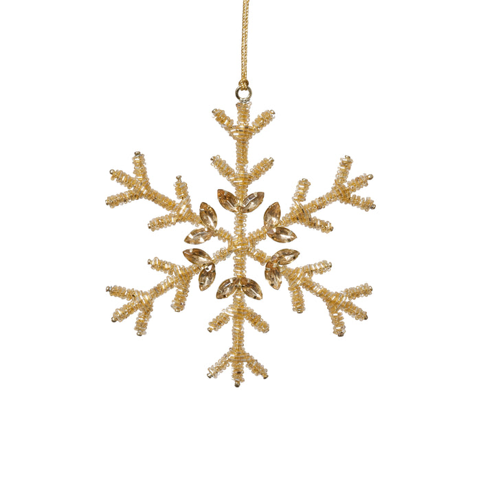 Gold snowflake ornament on a white background