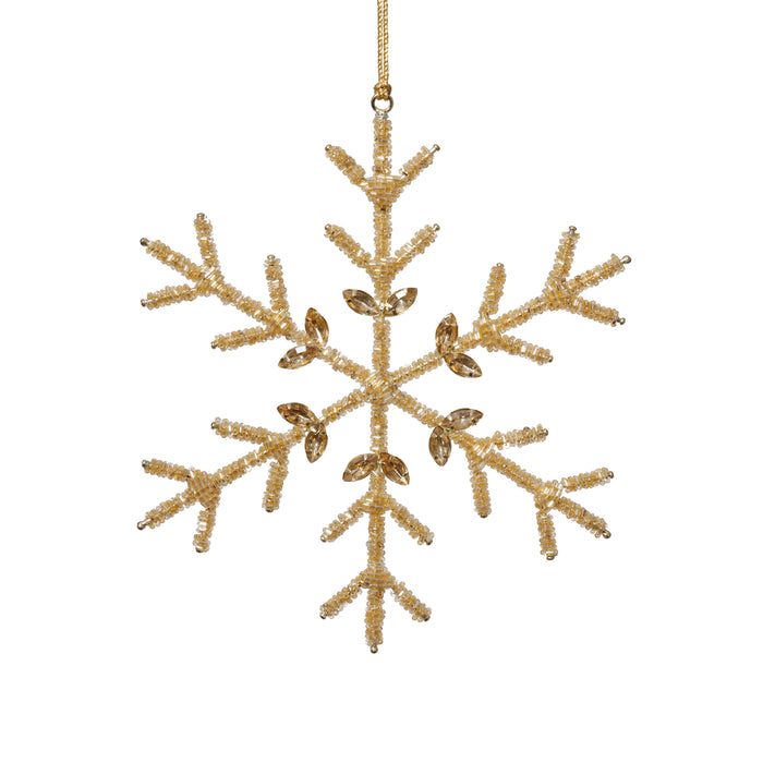 Gold snowflake ornament on a white background