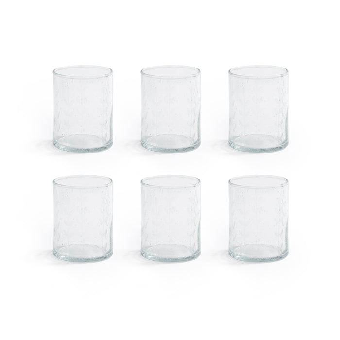 Set of six clear glass tumblers on a white background
