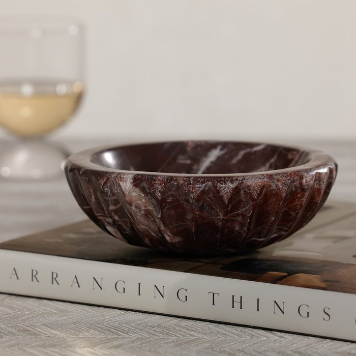 Marble-patterned bowl on a book with a blurred background