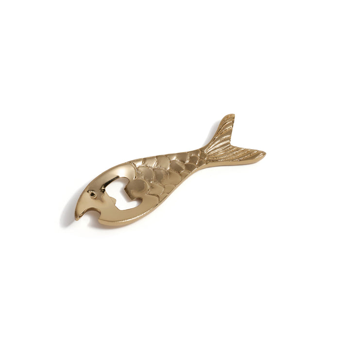Gold fish-shaped bottle opener on a white background