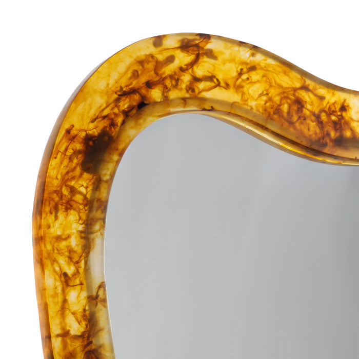 Curved amber-colored object on a white background