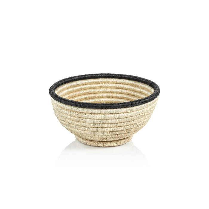 Small natural coiled abaca bowl with black rim, woven texture, on white background.