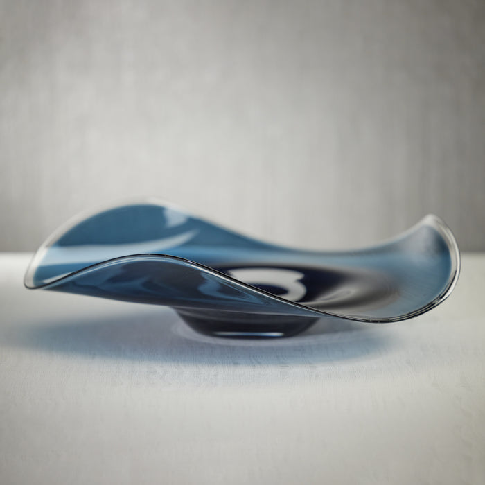 Sculptural glass piece on a neutral background
