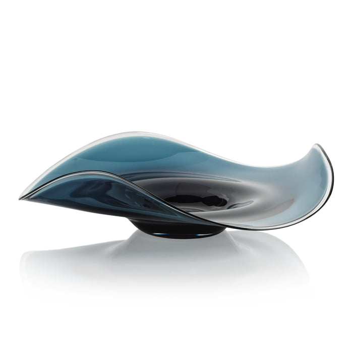 Sculptural glass piece with wavy design on a white background
