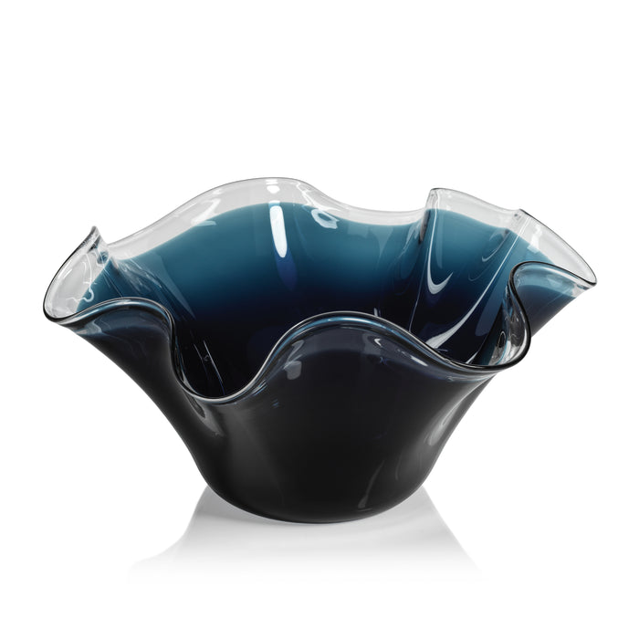Blue glass bowl with wavy design on a white background