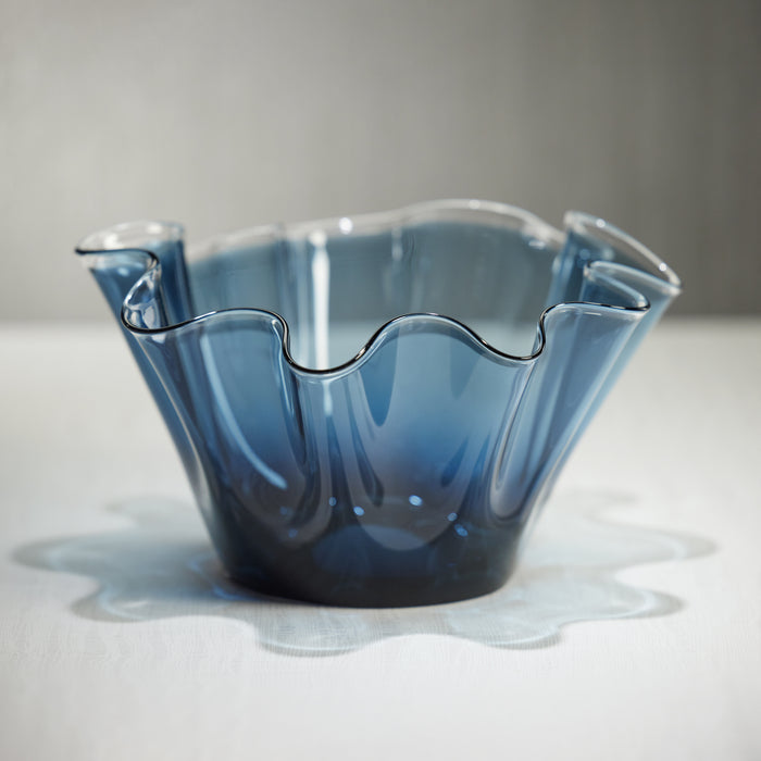 A 6-tall wave glass bowl with blue color, displaying an irregular shape with ruffled edges.