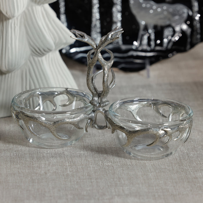 Glass dish with silver decorative stand on a neutral background
