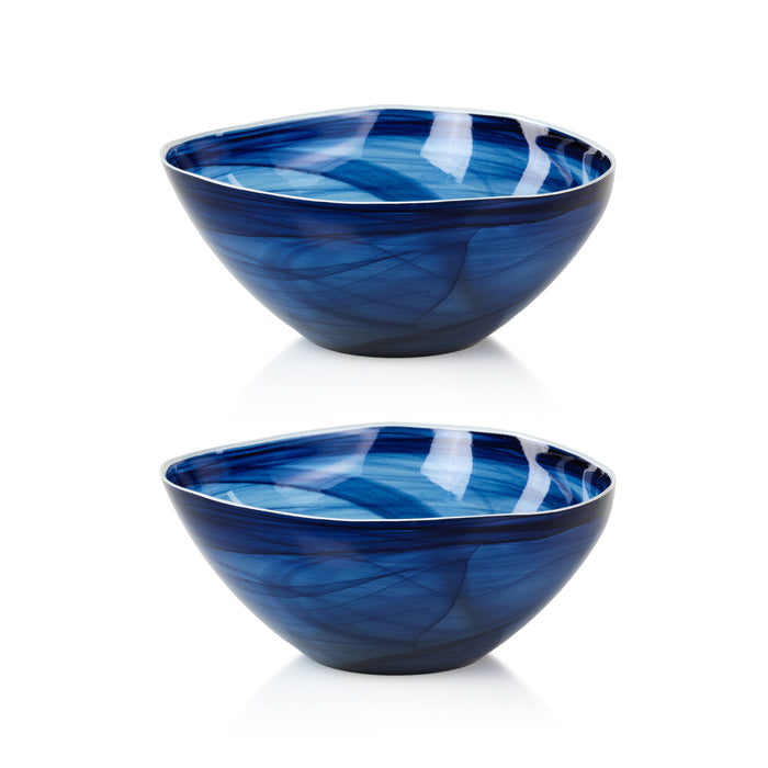 Two blue glass bowls with swirling patterns on a white background
