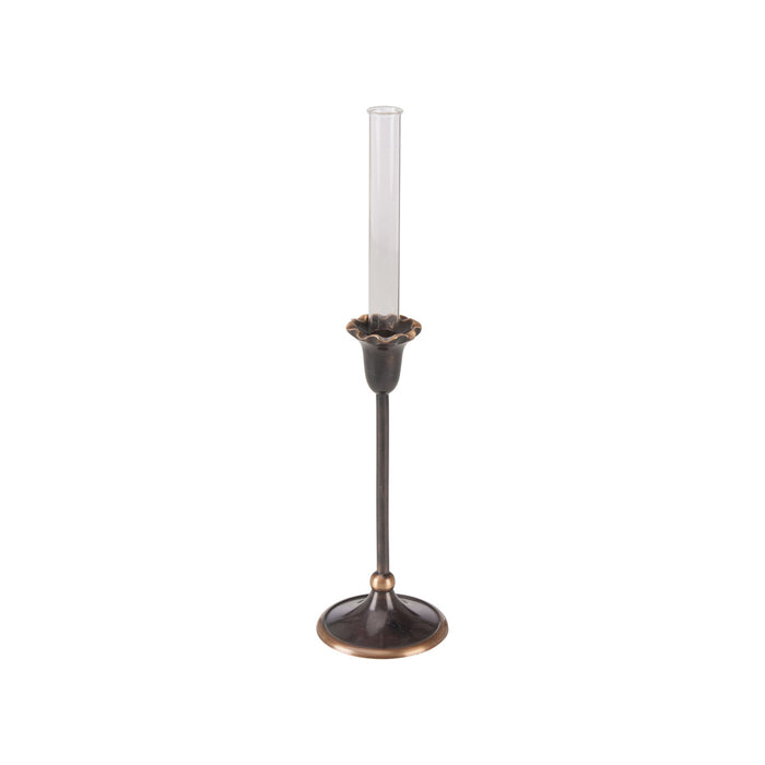 Bronze candle holder with a white candle on a white background