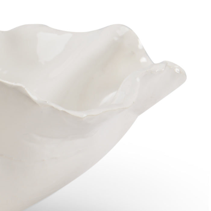 White ceramic dish with ruffled edge on a white background