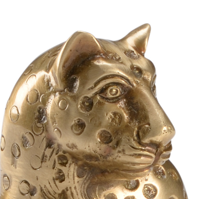Gold panther figurine with intricate patterns on a white background