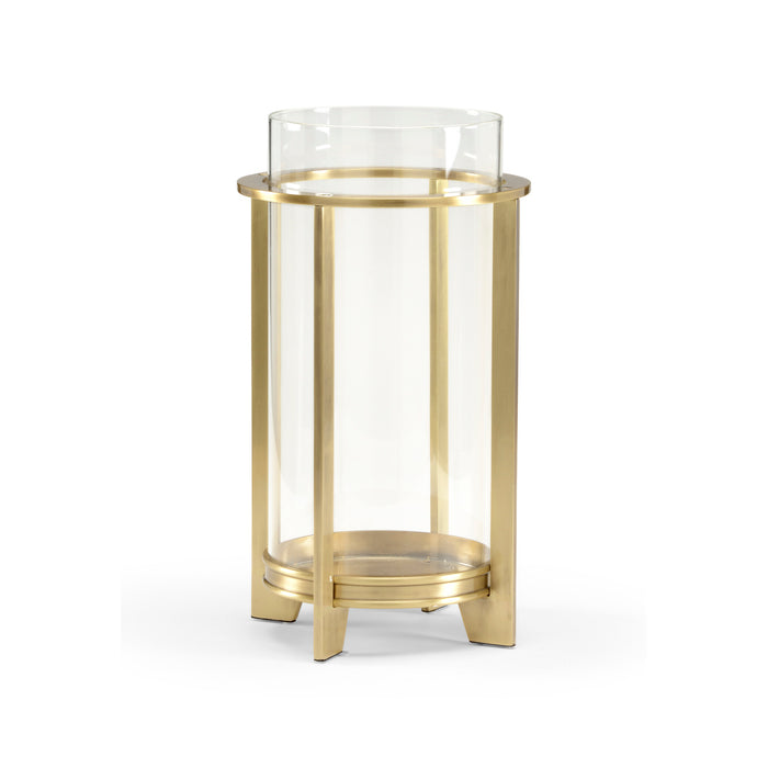 Gold side table with clear glass top on a white background
