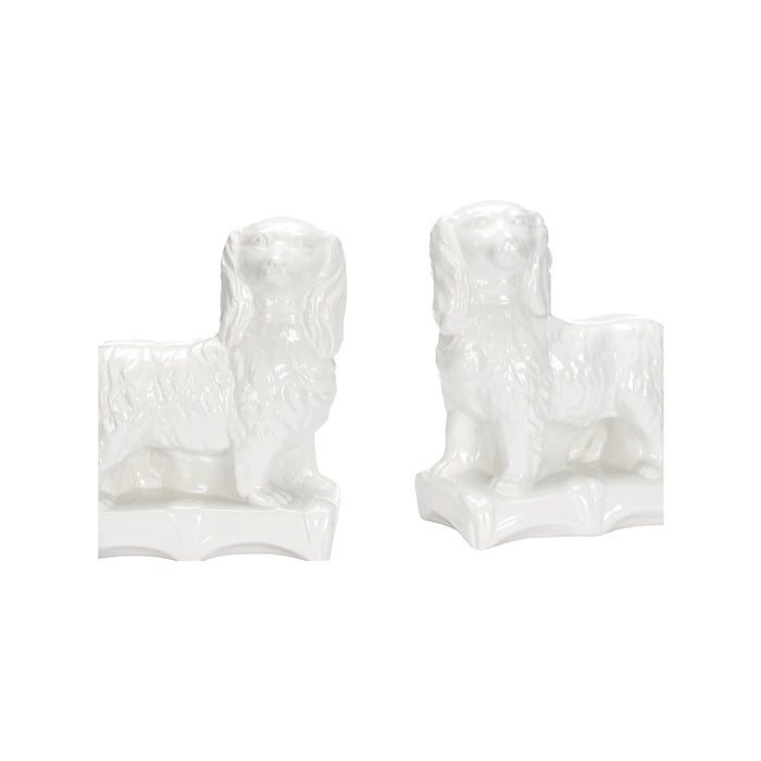Two white ceramic dog figurines on a white background