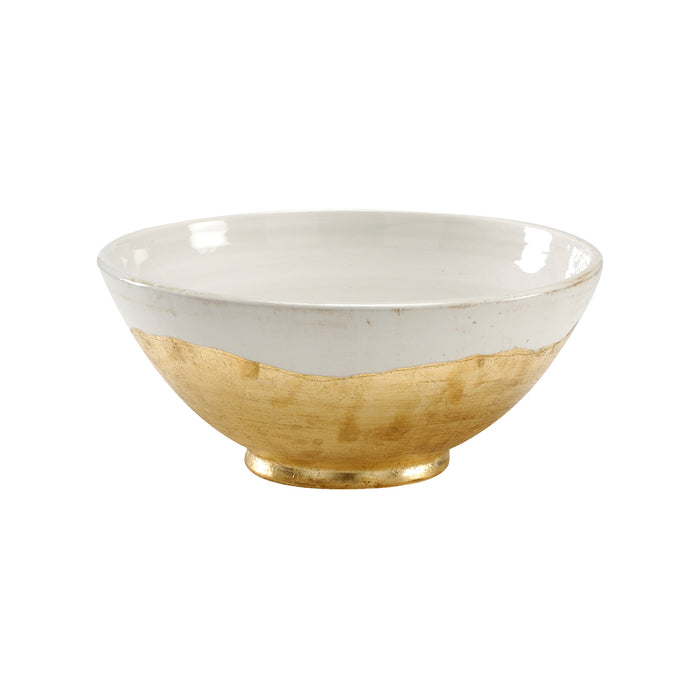 White ceramic bowl with gold base on a white background