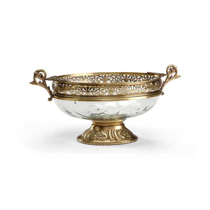 Decorative glass bowl with gold metal rim and handles on a white background
