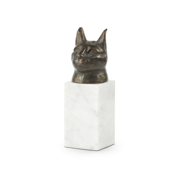 Bronze cat head sculpture on a white cube base against a white background