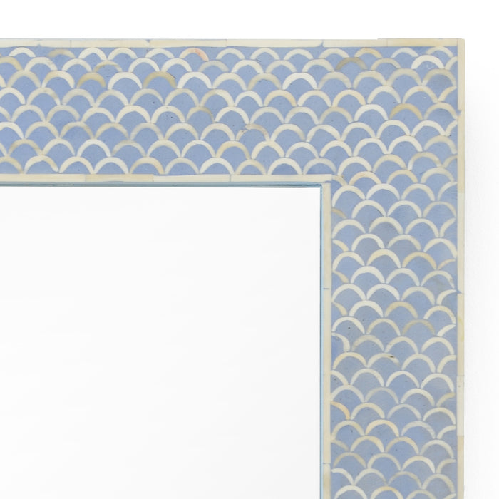 Decorative mirror with a blue and beige scallop pattern border on a white background