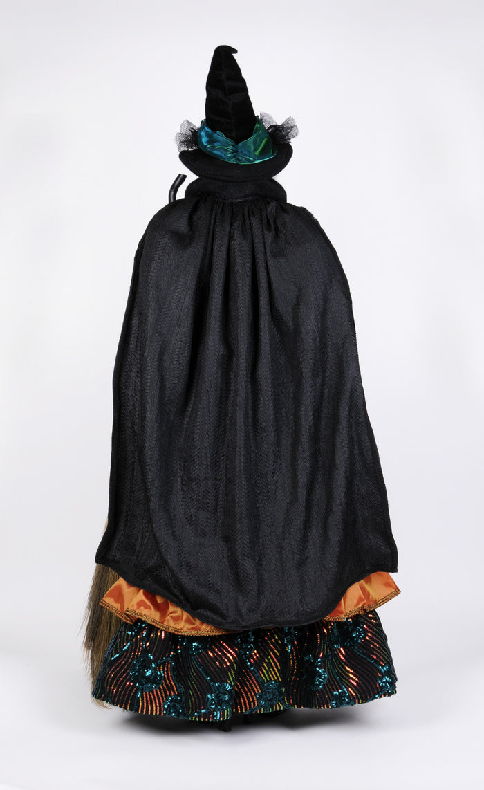 Costume with black witch cape and hat on a white background