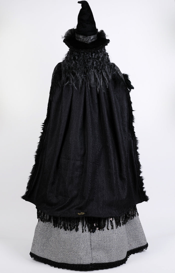 Black cape with fringes and a gray skirt on a white background