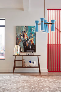 Modern interior with a table, decorative items, and a colorful abstract painting.