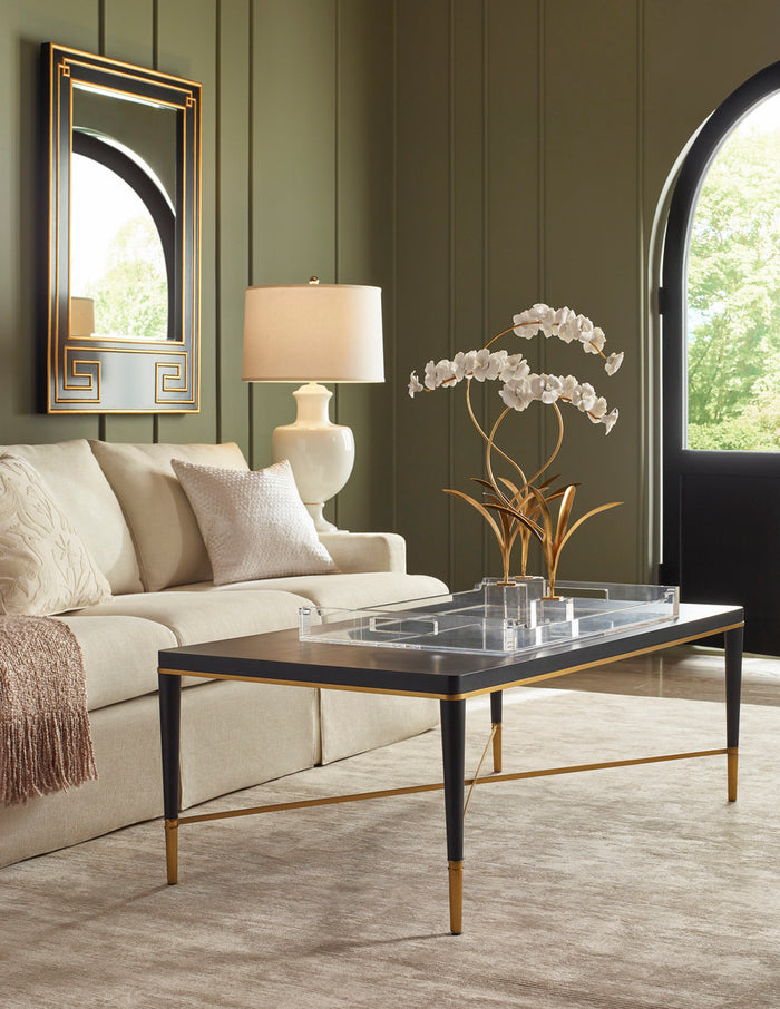 Living room with a beige sofa, coffee table, and decorative elements.