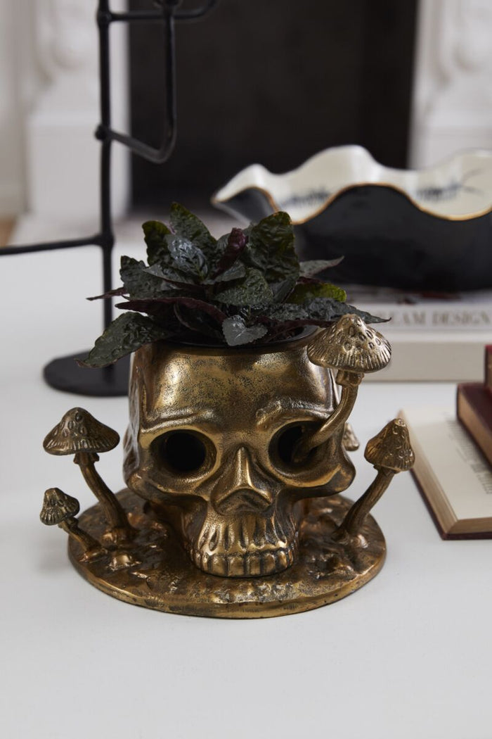 Decorative skull with a top hat and sunglasses on a black surface