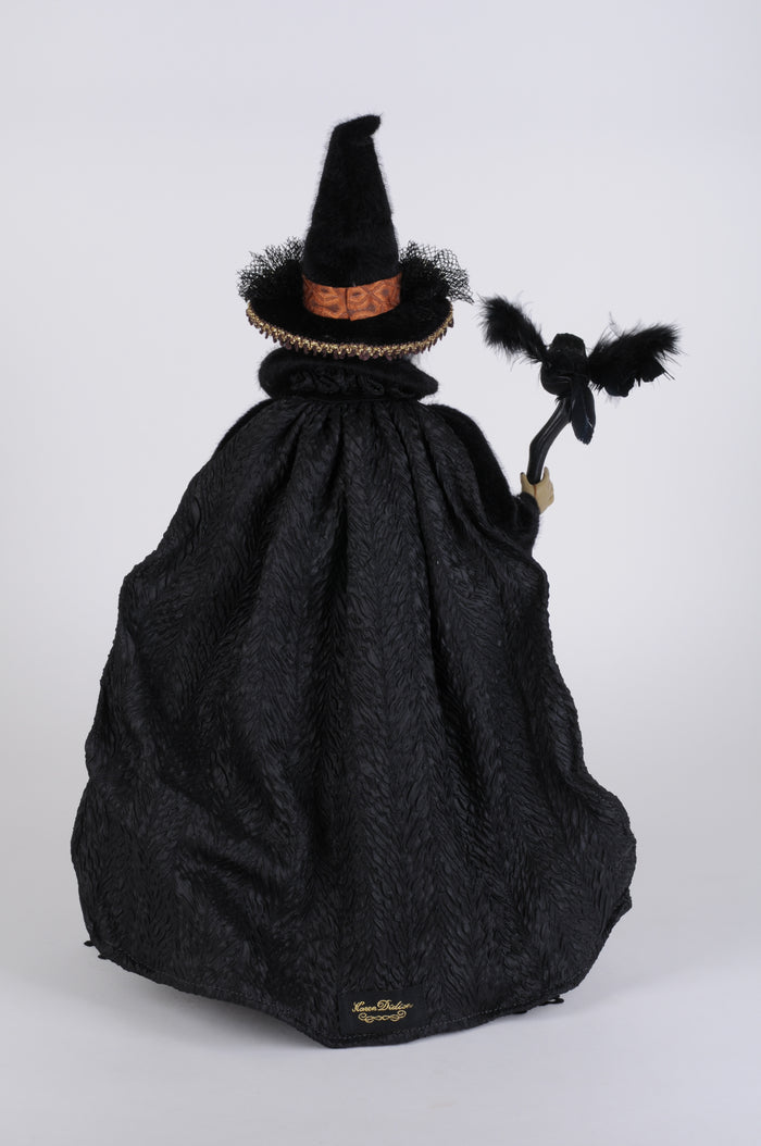 Black bag with a witch hat and broom on a white background
